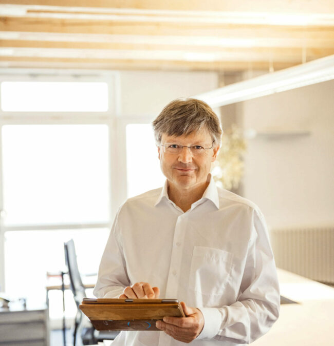 Profilbild von Peter Emmerling mit einem Tablet in der Hand